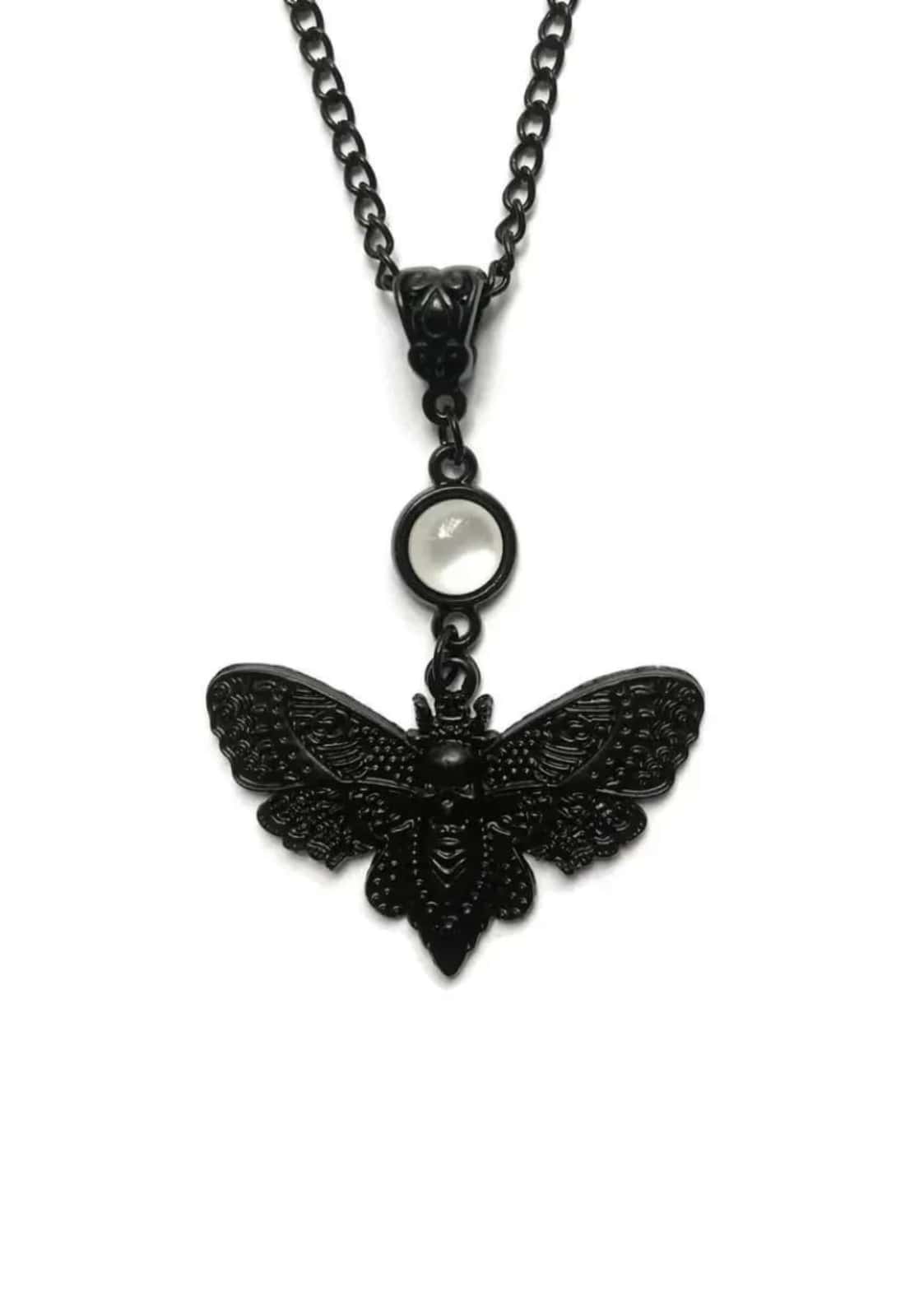 Schwarze moth pearl halskette mit detailreichem schwarzem moth anhänger und rundem mondstein akzent