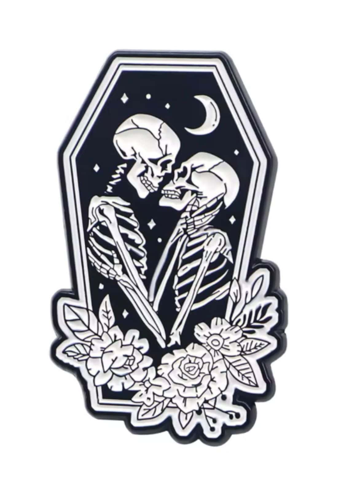 Gothic coffin love brooch featuring a skeleton with floral accents in a black coffin frame on black background