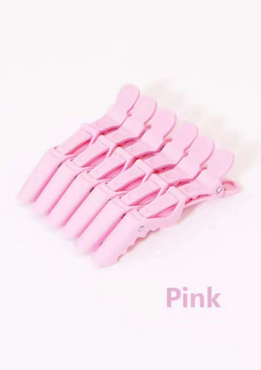 Set aus sechs pastellrosa plastik haarklemmen mit glatten kanten für kreative looks als zuverlässiges friseur zubehör