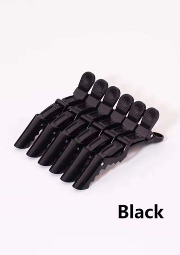 Set aus sechs schwarzen plastik haarspangen mit texturierter griffoberfläche für präzises abteilen im professionelles friseur zubehör