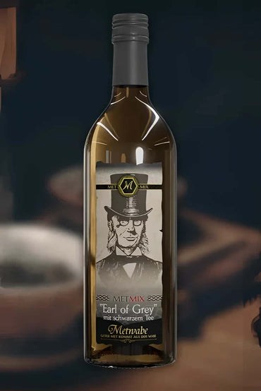 Eine transparente glasflasche mit silbernem deckel und label mit gentleman für den mix earl grey schwarzen tee von metnabe