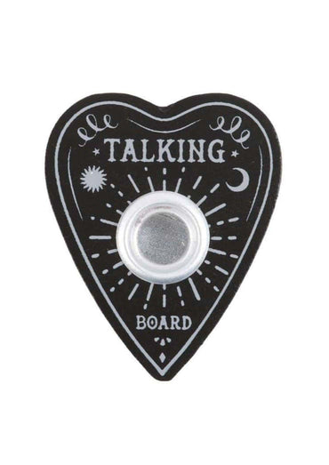 Schwarzes herzförmiges ouija bord kerze mit silbernem metallzentrum und weißer gotischer dekoration als kerzenständer