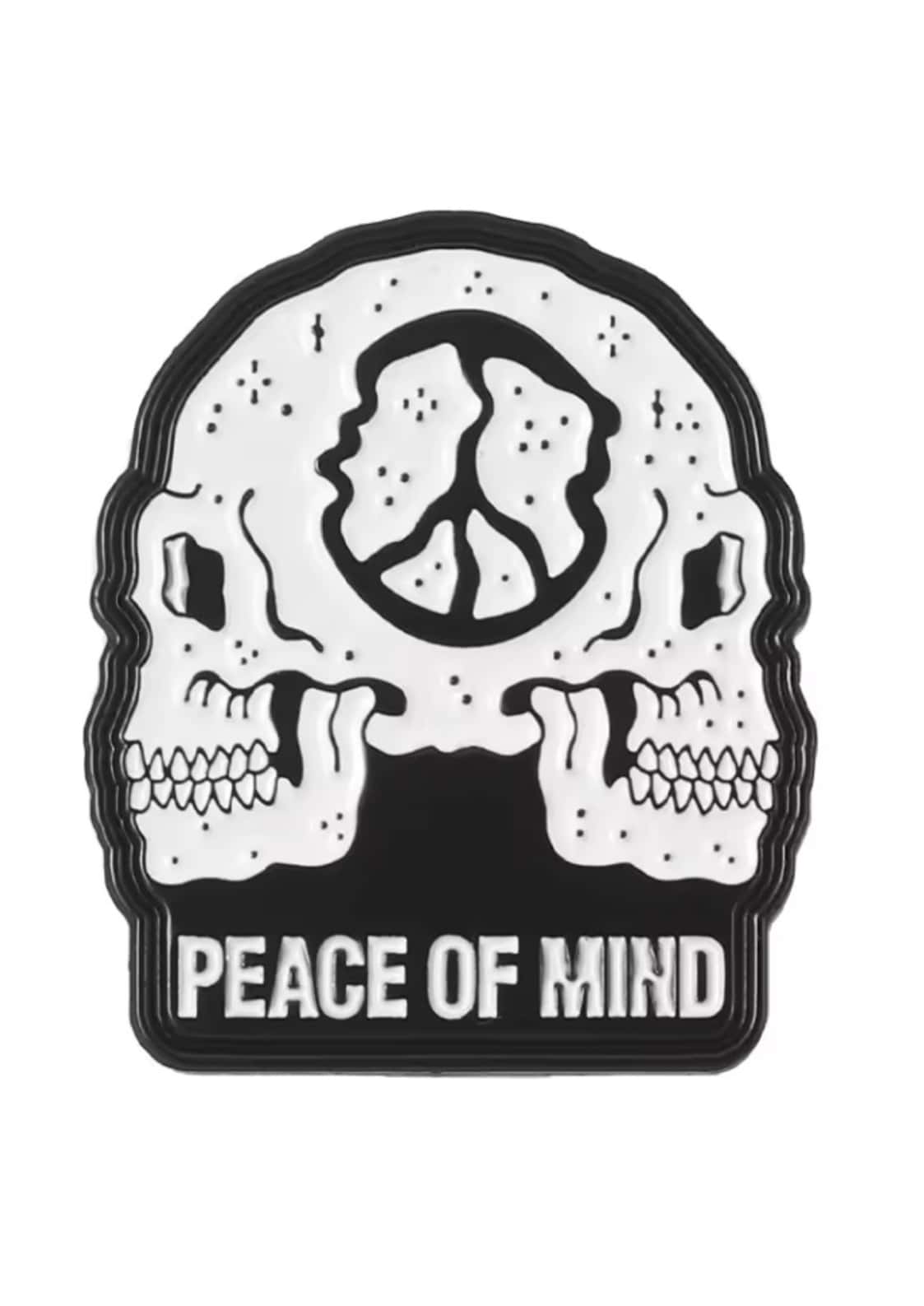 Black and white enamel pin featuring two skulls and a peace symbol labeled peace of mind for gothic horror fans
