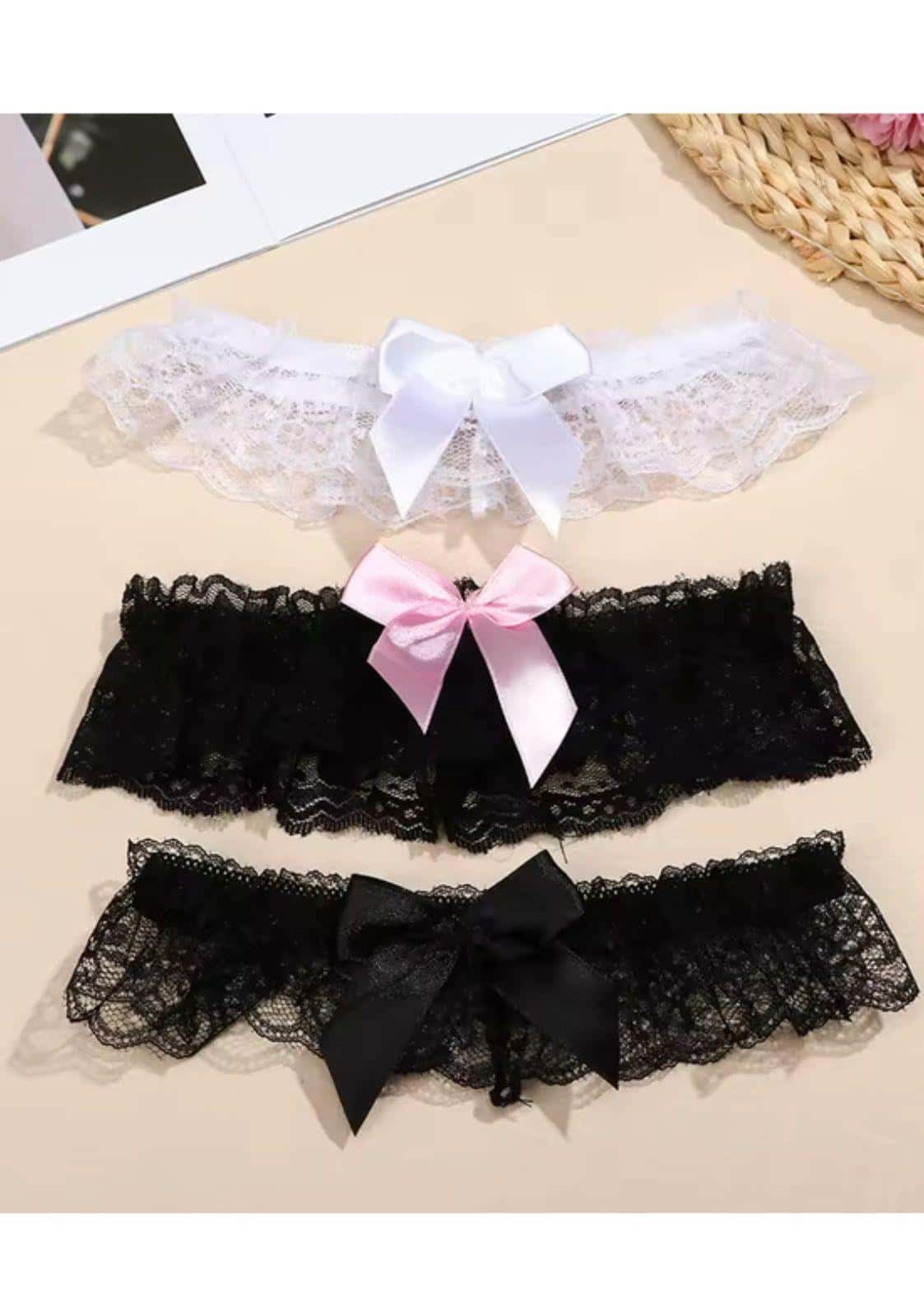 Drei spitze mit schleife klein strumpfbänder in weiß, rosa und schwarz mit rüschen für gothic kleidung und horror look