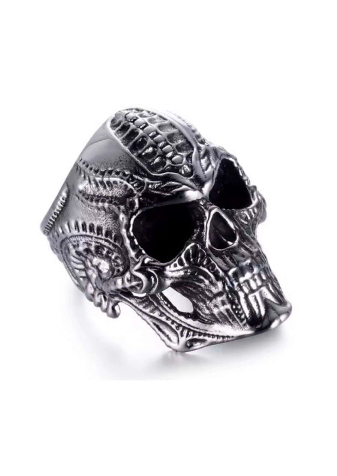 Biomechanic skull silver ring with intricate engraved patterns and textured metallic finish