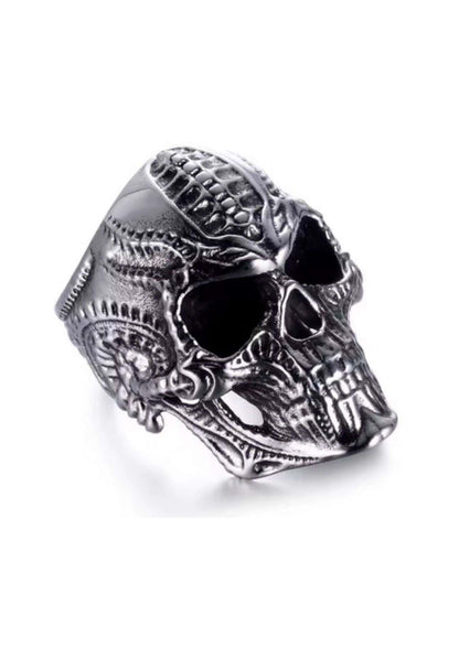 Biomechanic skull silver ring with intricate engraved patterns and textured metallic finish