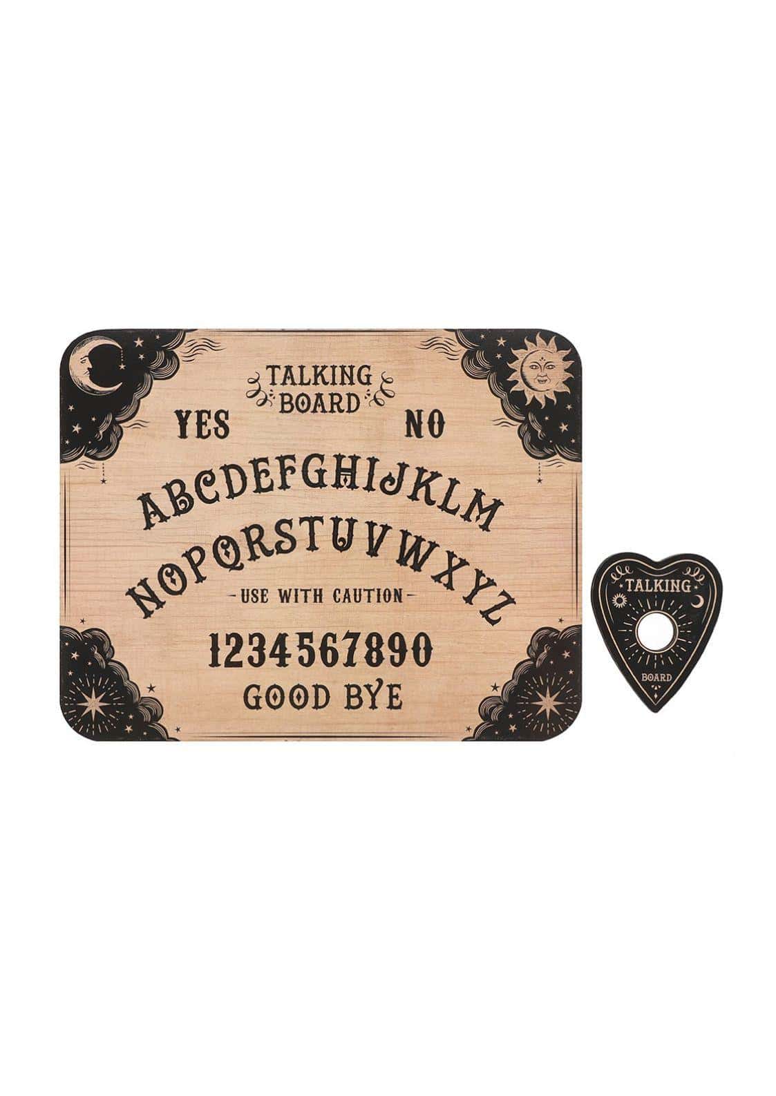 A rustic wooden classic style ouija board with black celestial designs and a matching heart-shaped planchette