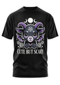 Schwarzes T-Shirt mit einer niedlichen gehörnten Kreatur und dem Text ’CUTE BUT SCARY’.