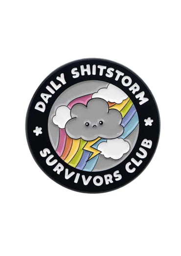 Black circular daily shitstorm pin with white text and colorful gothic horror cloud design featuring rainbow lightning bolt and smiling face