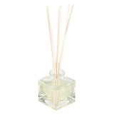 Schilfdiffusor in einer quadratischen Glasflasche.