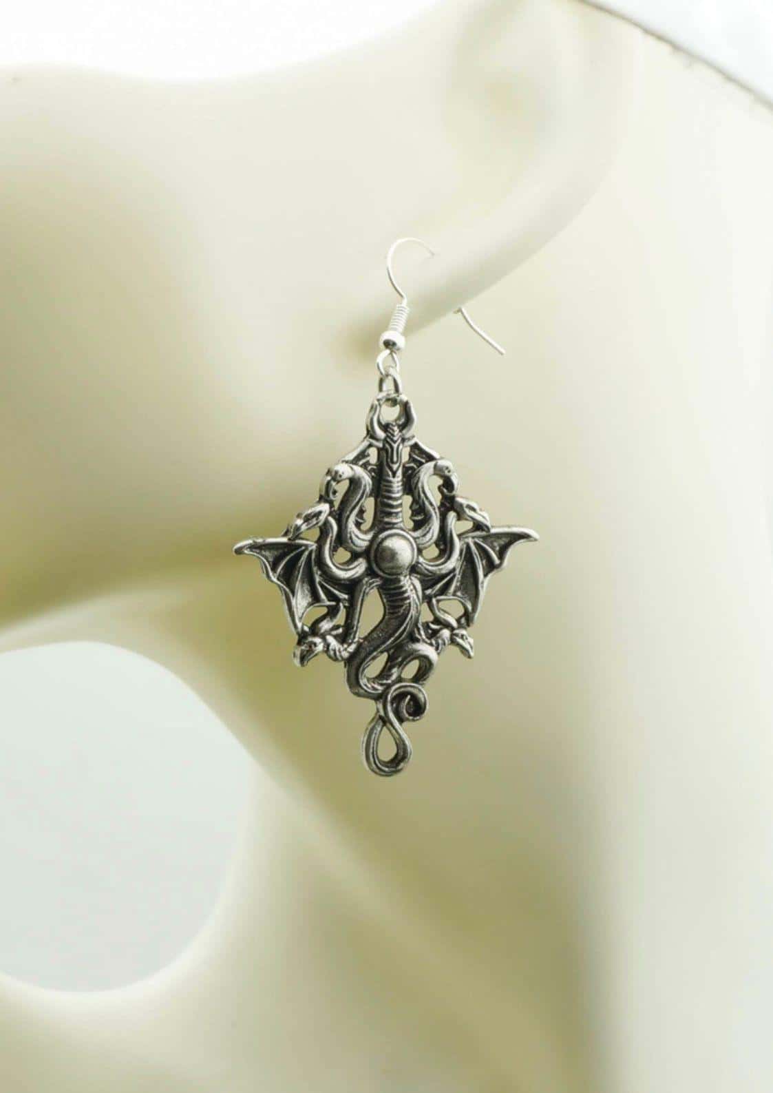 Silver dragon themed ohrringe mit filigranem flügeldesign und perlenakzent passend für gothic dark fashion