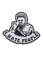 Weißer und schwarzer gestickter Aufnäher mit einer Person, die ein Messer hält, und dem Text ’I HATE PEOPLE’.