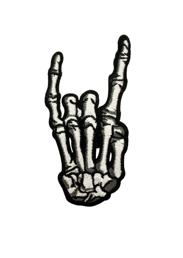 Ein schwarz-weiß patch-motiv metallknochen zeigt eine bestickte skelettische hand in rock-on-geste