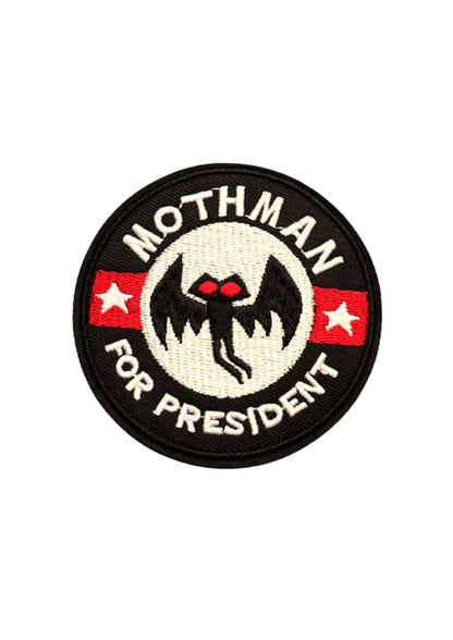Schwarzer rundpatch mit weiß besticktem mothman für president mit roten augen und roten streifen sowie sternen