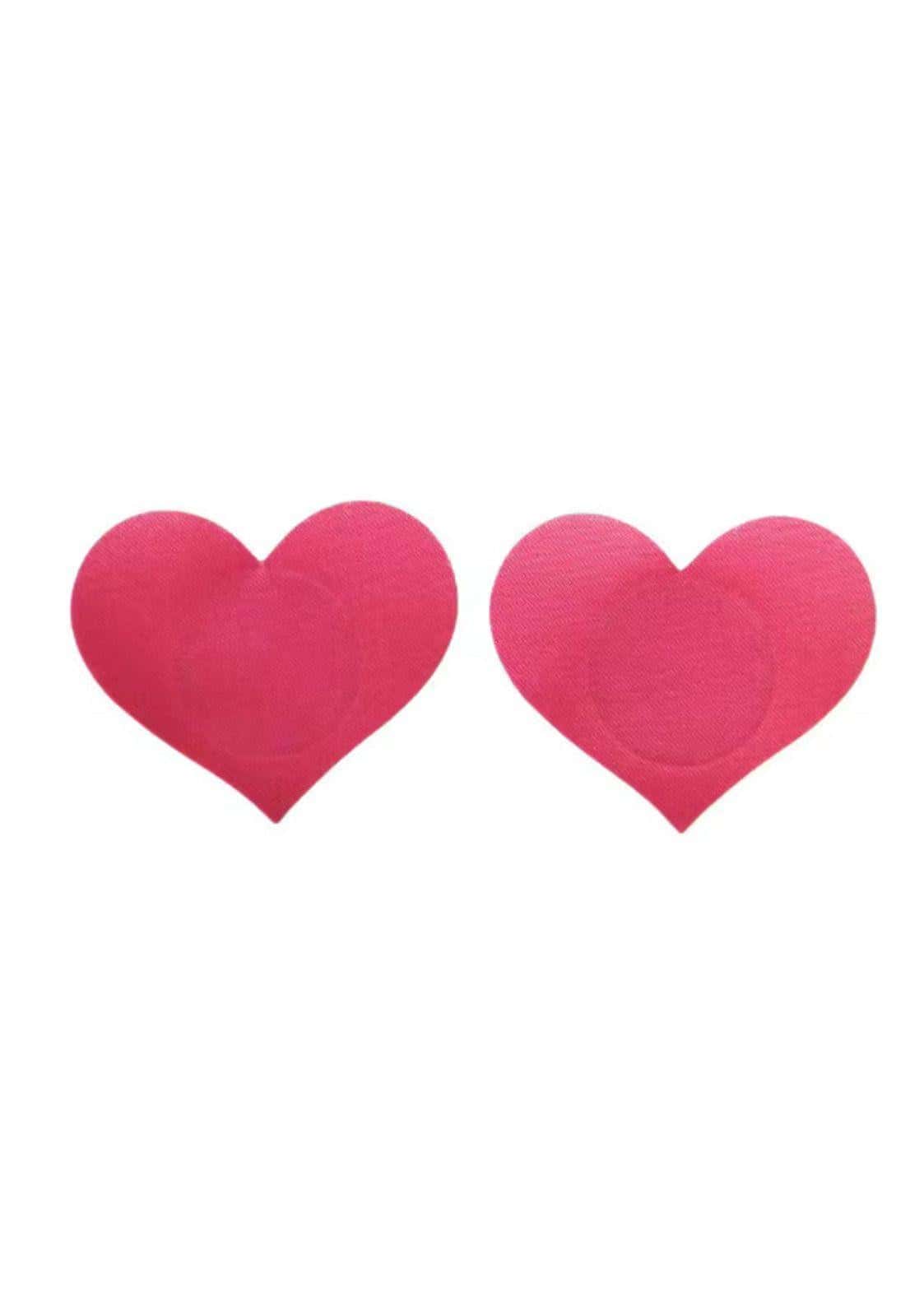 Paar leuchtend pinker herzförmiger haftbarer nippelpasties passend für gothic und dark fashion stil