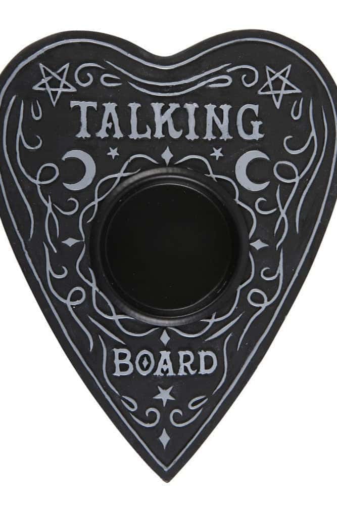 Schwarzes herzförmiges ouija board tealight mit silbernen gravuren als kerzenständer