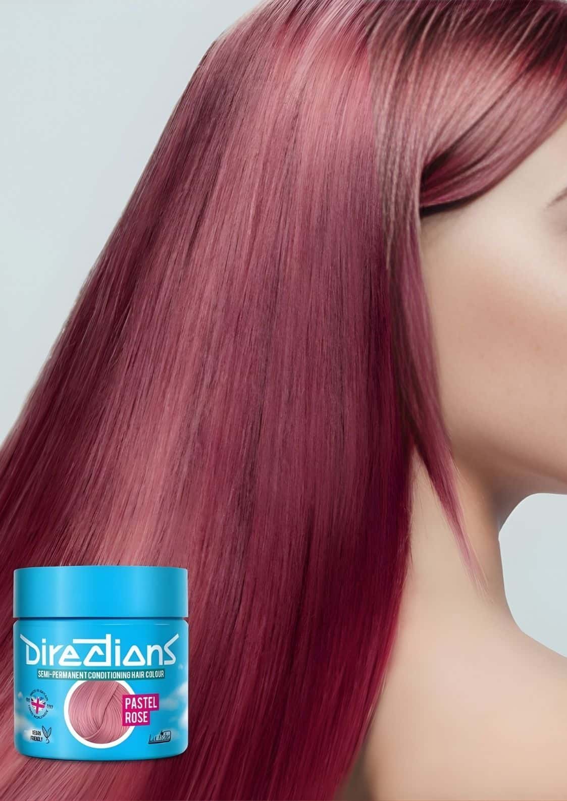 Ein lebendiges Pastell-Rosa semi-permanentes Pflegeshampoo-Haarfarbe in einem schlanken blauen Glas mit dem Markennamen ’direcions’ prominent angezeigt.