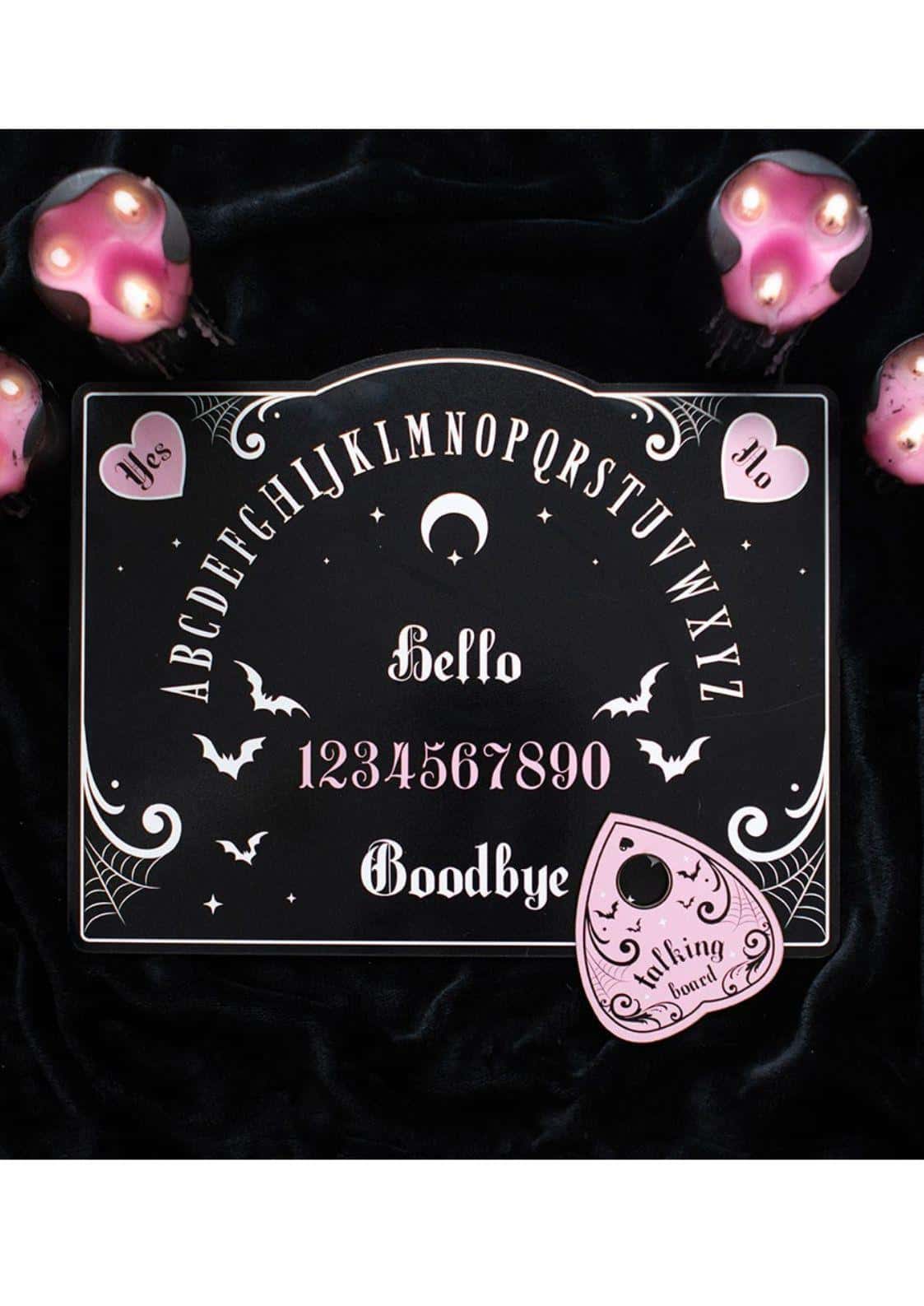 Pink and black ouija board with white lettering pink accents crescent moon bats hello and goodbye with matching pink talking bowl