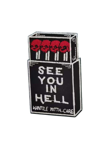 Black and white embroidered gothic patch shaped like a matchbox with red skulls and see you in hell text