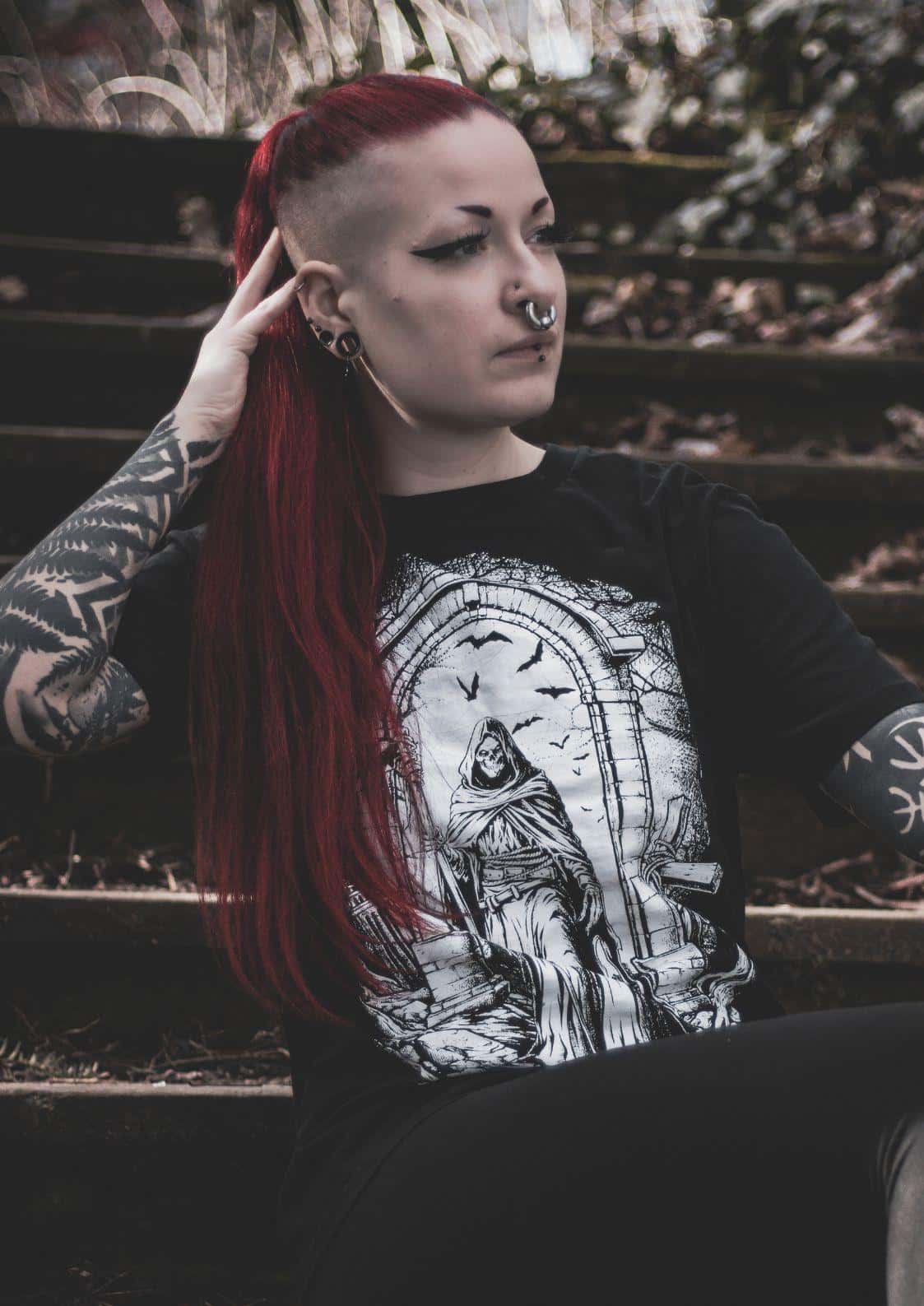 Black long-sleeved gothic shirt featuring a white horror graphic of a hooded figure in an arched doorway with bats