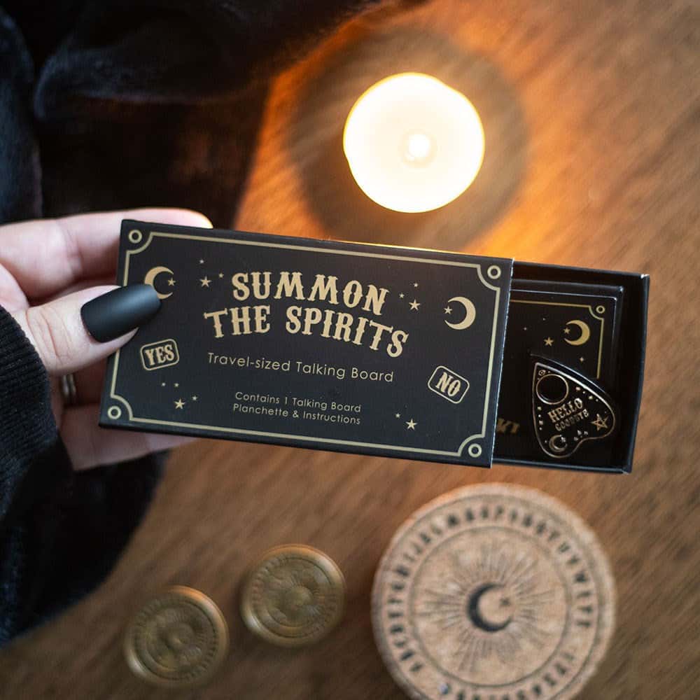 Travel ouija board in black and gold with summon the spirits design in a decorative celestial travel box