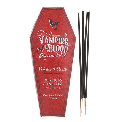 Rote vampire blood räucherstäbchen mit schwarzen stäbchen und goldspitzen im sargförmigen halter