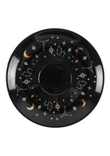 Schwarze Untertasse mit himmlischen Motiven.